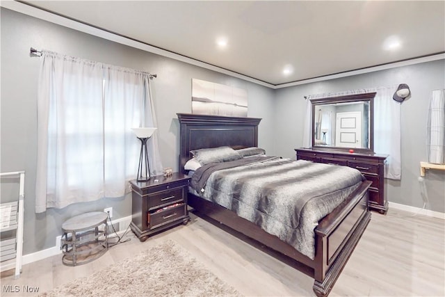 bedroom with light wood-type flooring, crown molding, baseboards, and recessed lighting