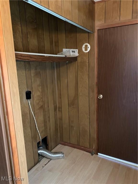 room details featuring wood finished floors and wooden walls