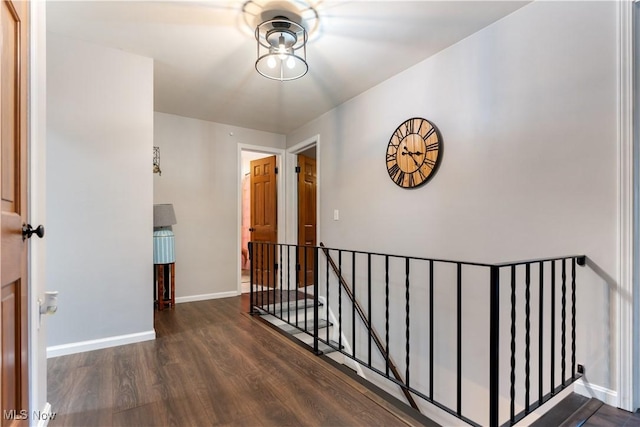 2119 Devonshire Dr NW, Canton, OH 44708 - hallway featuring wood finished floors, baseboards, and an upstairs landing
