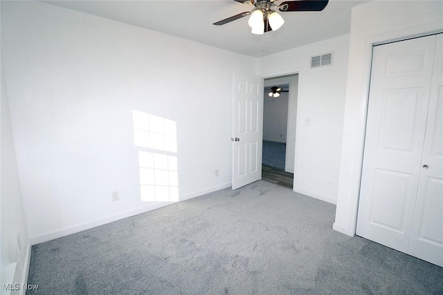 unfurnished bedroom featuring a closet, baseboards, carpet flooring, a ceiling fan, and visible vents