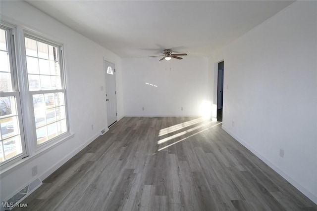 unfurnished living room featuring visible vents, ceiling fan, wood finished floors, and baseboards