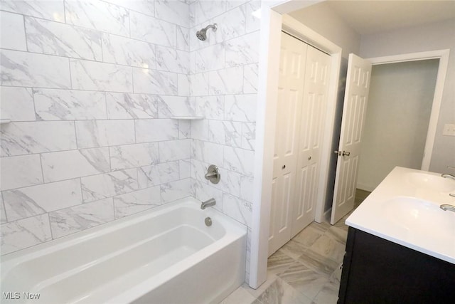 full bathroom featuring a closet, double vanity, shower / tub combination, marble finish floor, and a sink