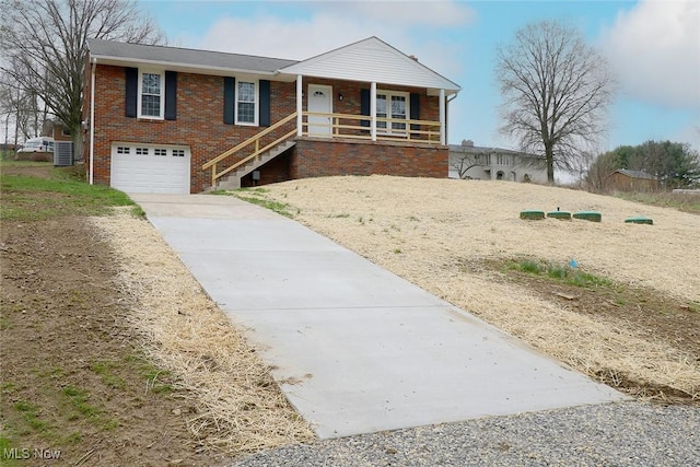 ranch-style home with central AC, covered porch, brick siding, an attached garage, and concrete driveway