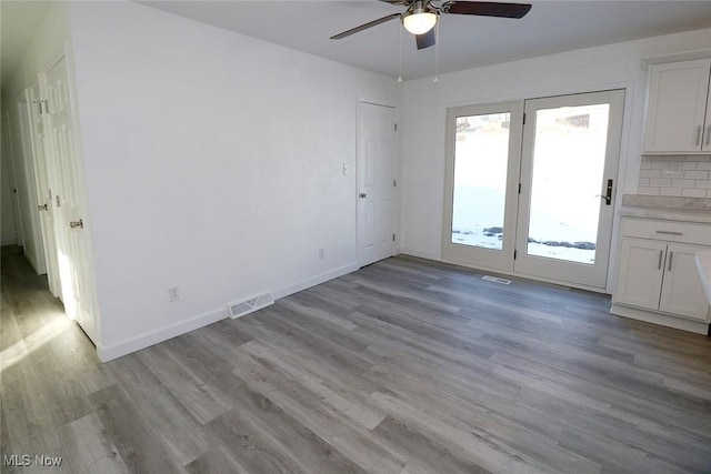 interior space featuring light wood-style floors, visible vents, and a ceiling fan