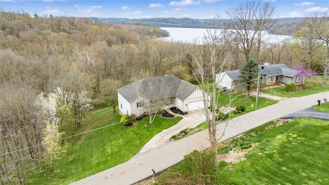 aerial view with a water view and a forest view