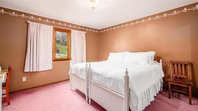 carpeted bedroom featuring baseboards