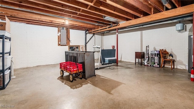 unfinished basement with electric panel and brick wall