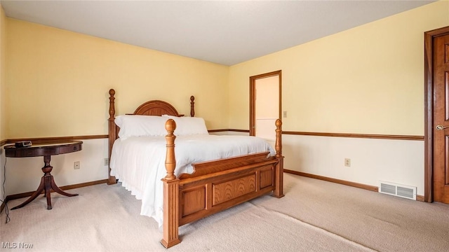bedroom with visible vents, light colored carpet, and baseboards