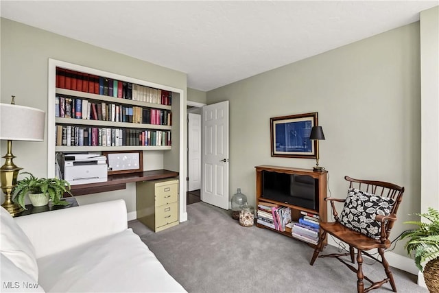 living area featuring carpet floors and baseboards