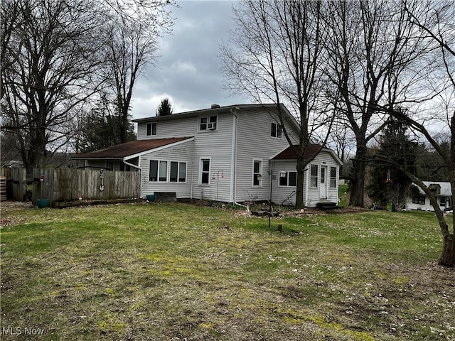 rear view of house with a yard