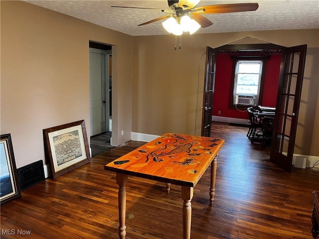 dining space featuring ceiling fan, cooling unit, a textured ceiling, visible vents, and wood finished floors