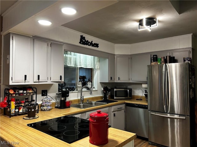 3265 Tieber Rd, Stockport, OH 43787 - kitchen featuring recessed lighting, appliances with stainless steel finishes, wood finished floors, light countertops, and a sink