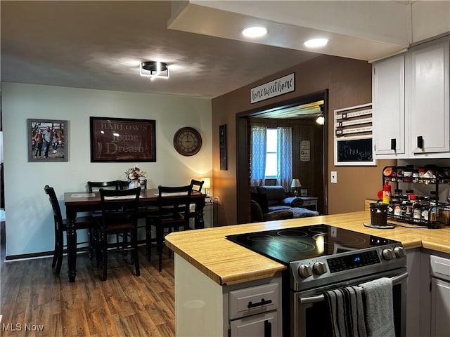 3265 Tieber Rd, Stockport, OH 43787 - kitchen with a peninsula, white cabinets, dark wood-style flooring, electric stove, and wood counters