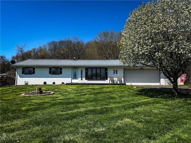 3265 Tieber Rd, Stockport, OH 43787 - back of house featuring brick siding, a standing seam roof, and a lawn