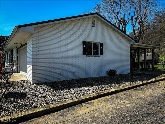 3265 Tieber Rd, Stockport, OH 43787 - view of side of property with brick siding and a garage