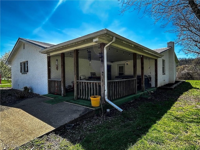 3265 Tieber Rd, Stockport, OH 43787 - exterior space featuring a chimney, metal roof, a patio area, and brick siding