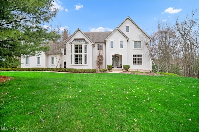 view of front of home with a front lawn and stucco siding