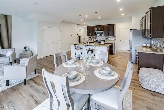 850-4 Dipper Ln, Aurora, OH 44202 - dining space featuring light wood-type flooring, recessed lighting, and stairs