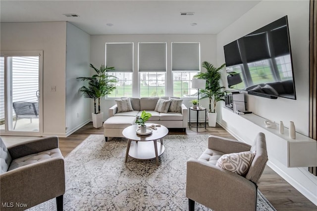 850-4 Dipper Ln, Aurora, OH 44202 - living area featuring visible vents, baseboards, and a healthy amount of sunlight