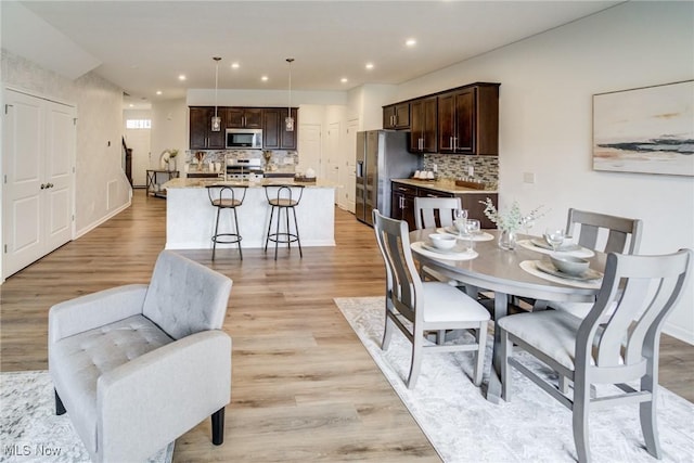 850-4 Dipper Ln, Aurora, OH 44202 - dining room featuring baseboards, light wood finished floors, and recessed lighting
