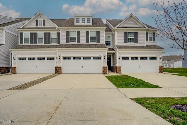 850-4 Dipper Ln, Aurora, OH 44202 - view of front of property with an attached garage, roof with shingles, driveway, and brick siding