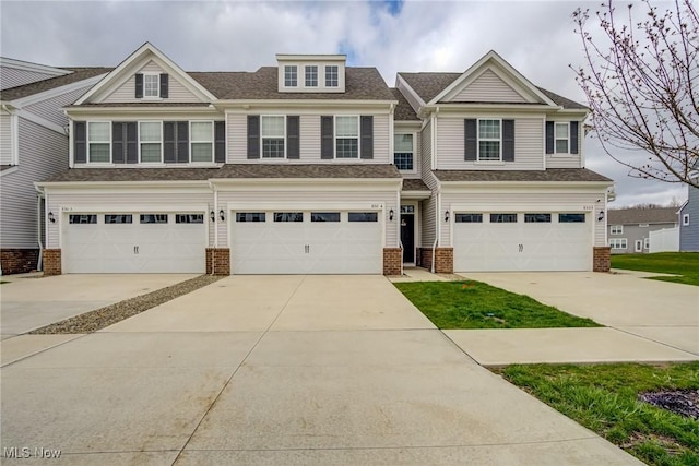 850-4 Dipper Ln, Aurora, OH 44202 - view of front facade featuring a shingled roof, brick siding, driveway, and an attached garage