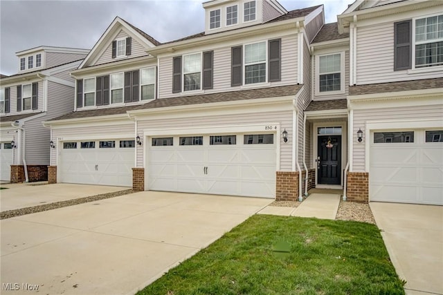 850-4 Dipper Ln, Aurora, OH 44202 - multi unit property with driveway, a garage, and brick siding