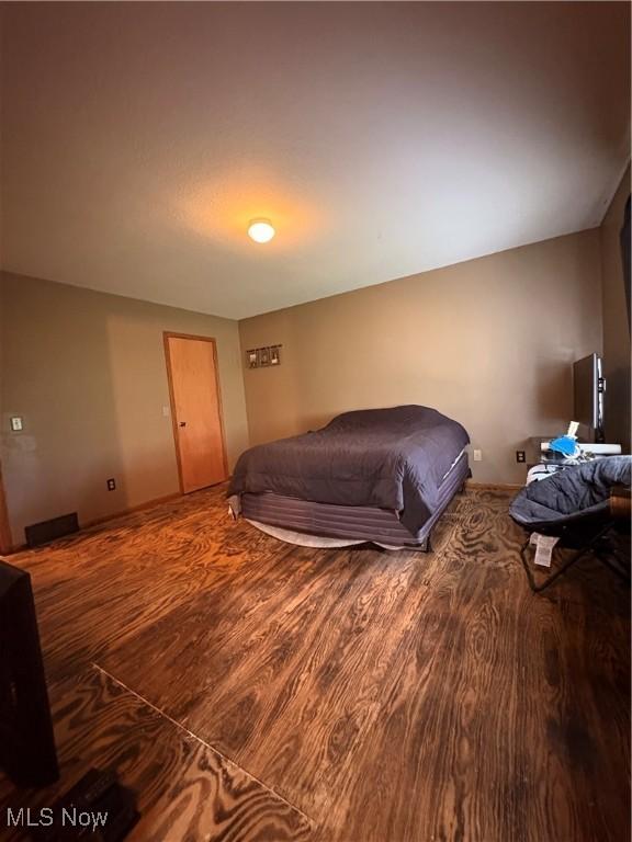 bedroom featuring wood finished floors