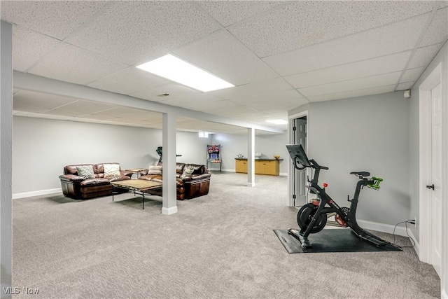 workout area with a paneled ceiling, baseboards, and carpet