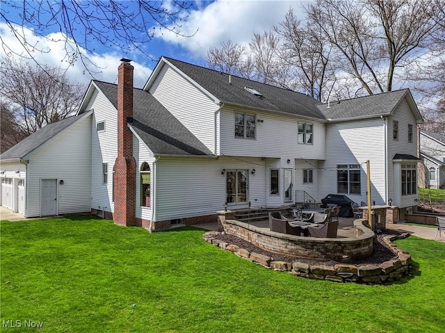 back of property with a yard, a patio, and a chimney