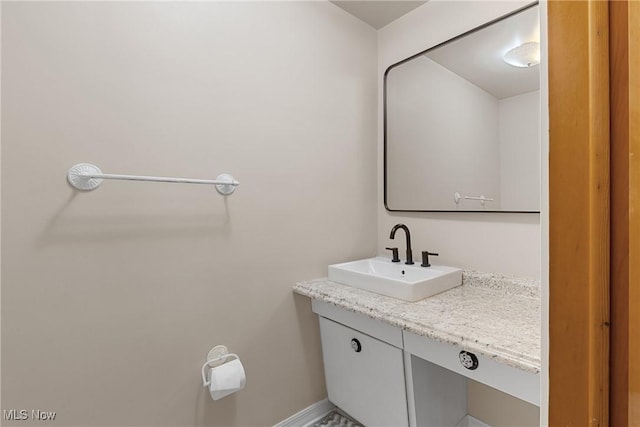 bathroom with baseboards and vanity