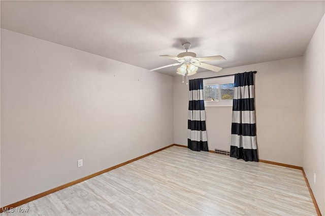 unfurnished room with visible vents, baseboards, ceiling fan, and wood finished floors