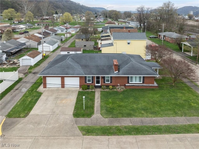 drone / aerial view featuring a mountain view and a residential view