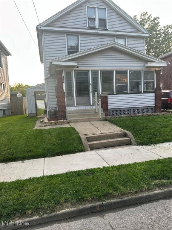 120 Sayers Ave, Niles, OH 44446 - american foursquare style home with a sunroom, a front yard, and entry steps