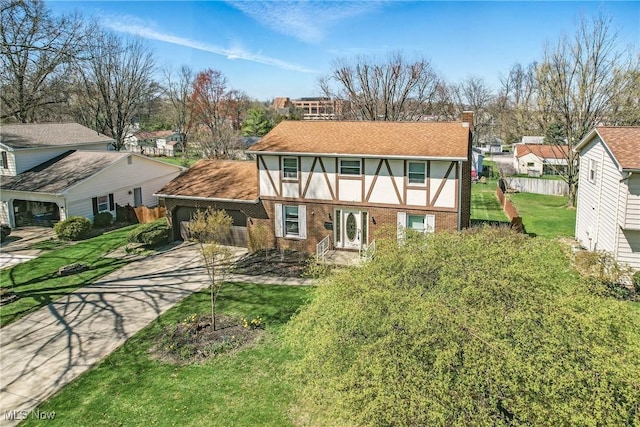2262 Tanglewood Dr, Salem, OH 44460 - view of front of home with a residential view, brick siding, a chimney, a shingled roof, and driveway