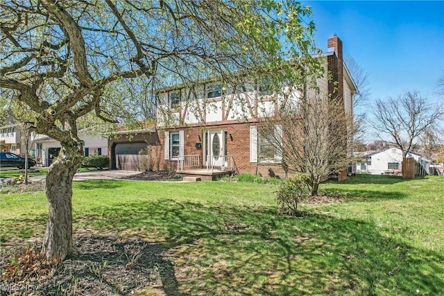 2262 Tanglewood Dr, Salem, OH 44460 - view of front facade with an attached garage, a front yard, driveway, a chimney, and brick siding
