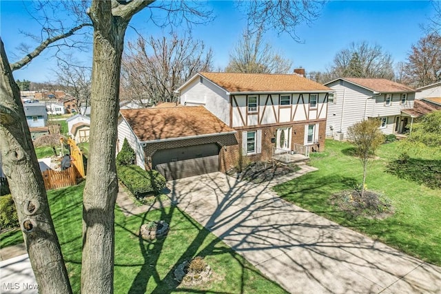 2262 Tanglewood Dr, Salem, OH 44460 - tudor-style house with brick siding, concrete driveway, an attached garage, a chimney, and a shingled roof
