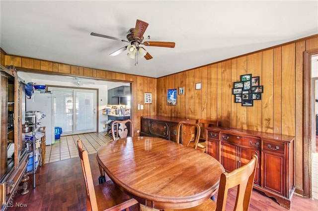 2262 Tanglewood Dr, Salem, OH 44460 - dining area with ceiling fan, wooden walls, and wood finished floors