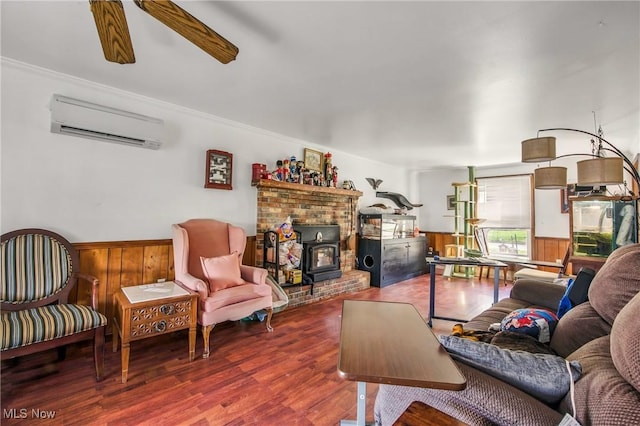 2262 Tanglewood Dr, Salem, OH 44460 - living area with a wall unit AC, wood finished floors, a wainscoted wall, a wood stove, and wooden walls