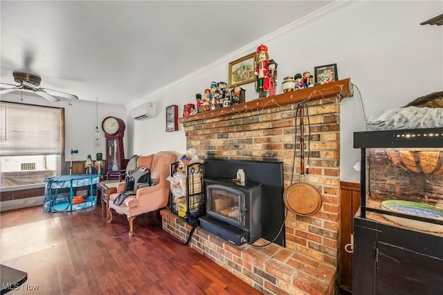 2262 Tanglewood Dr, Salem, OH 44460 - living area with a wood stove, a wall mounted AC, a ceiling fan, crown molding, and wood finished floors