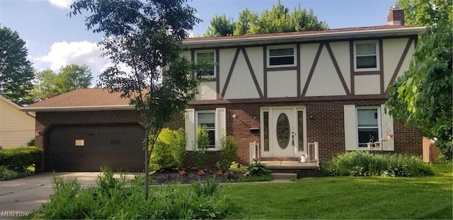 2262 Tanglewood Dr, Salem, OH 44460 - tudor home featuring brick siding, a front lawn, driveway, and an attached garage