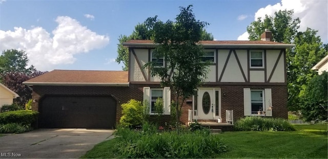 2262 Tanglewood Dr, Salem, OH 44460 - tudor-style house featuring brick siding, an attached garage, and driveway