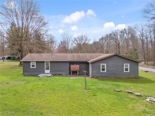 back of house with a lawn