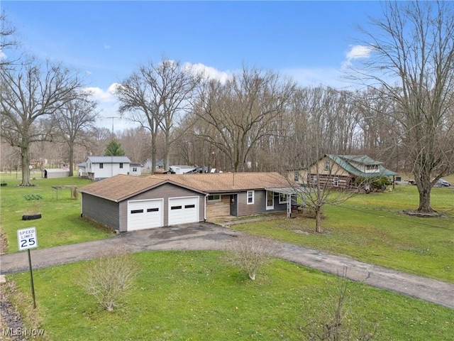 ranch-style home featuring an attached garage, driveway, and a front lawn