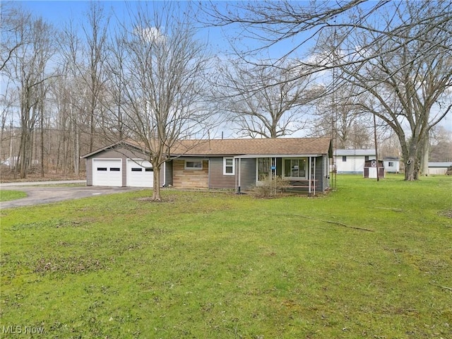 view of front of property with a garage, aphalt driveway, covered porch, and a front yard