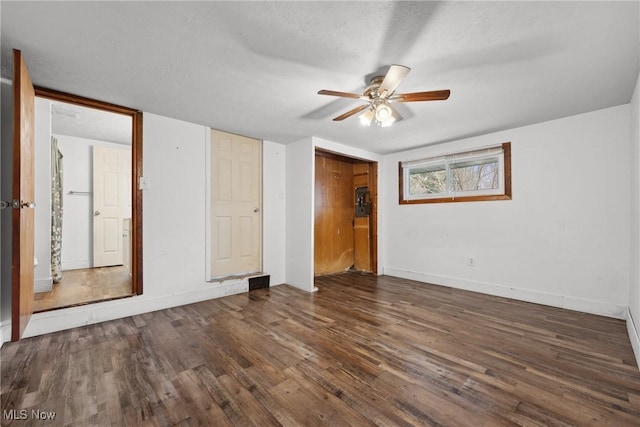 unfurnished room featuring baseboards, a ceiling fan, and wood finished floors