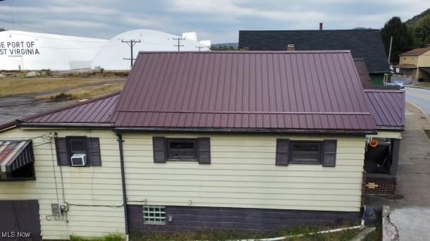 view of property exterior featuring a standing seam roof and metal roof
