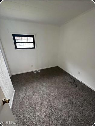 spare room featuring baseboards, carpet, and visible vents