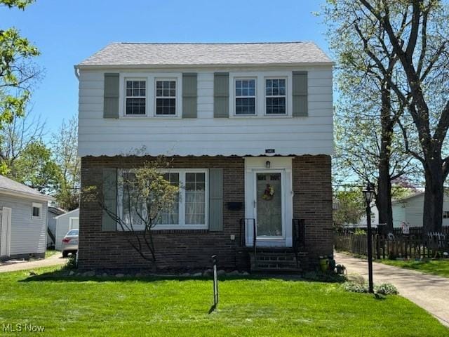 440 Wayne Ave, Akron, OH 44301 - colonial home with a front yard, fence, and brick siding