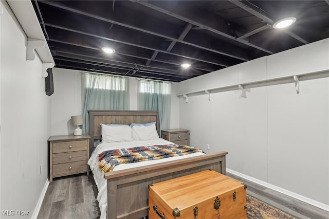 bedroom featuring baseboards and wood finished floors